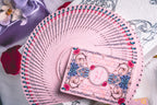 Story of Rose pink playing cards fanned beside the collector's box