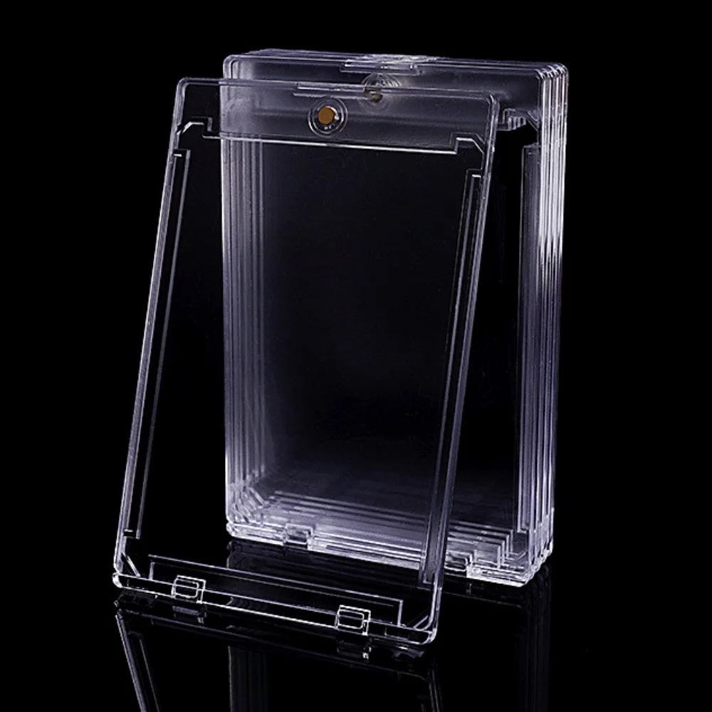 Stack of clear hard plastic card holders on a dark surface